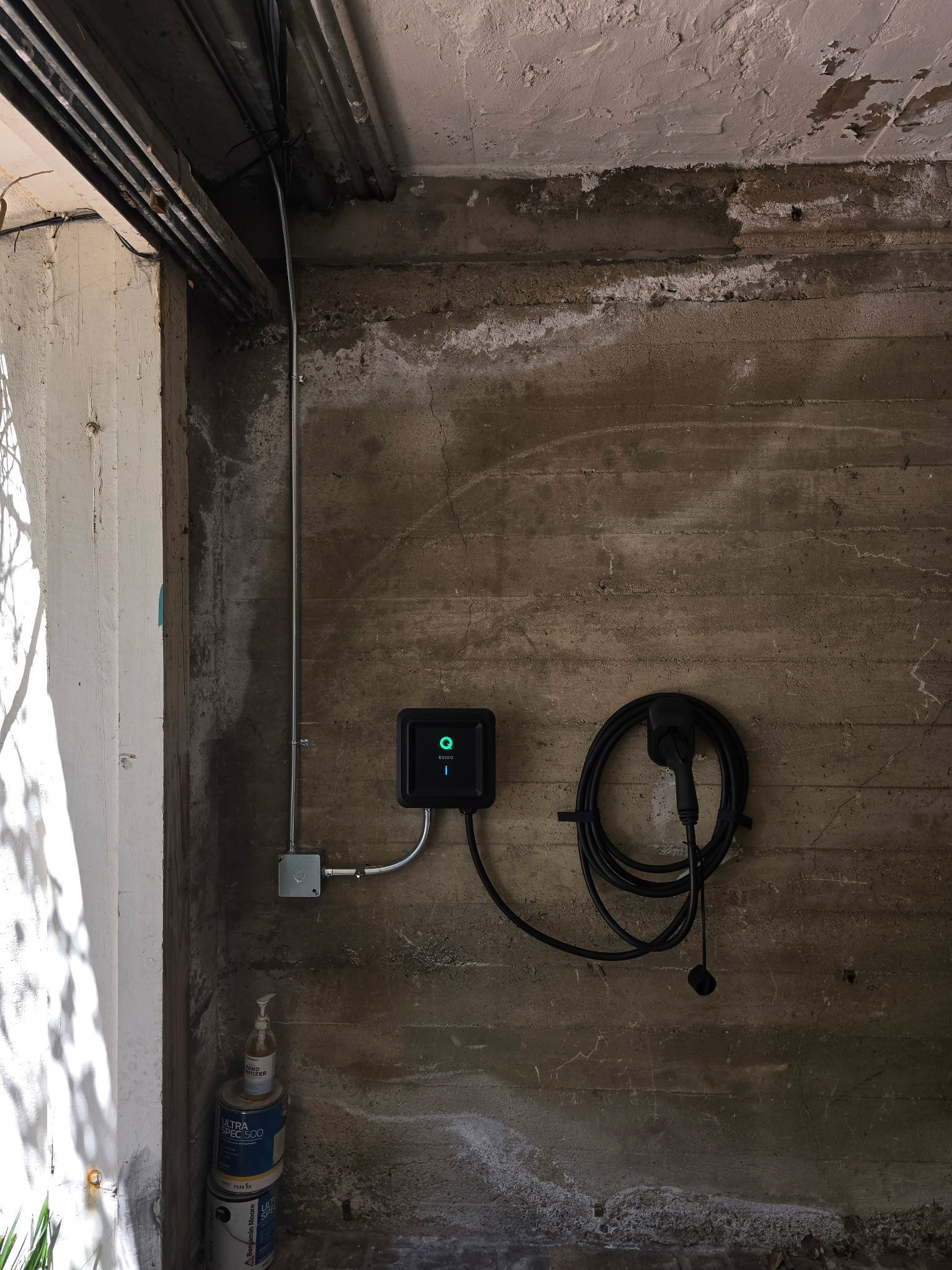 Level 2 wall-mounted EV charger installation in a residential garage